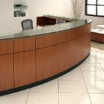 Willow Reception Units 
Willow features a bowfront design with laminate or wood veneer, a glass transaction top and a 3” overhang on satin chrome stand-offs. It includes striking accents of black reveals, with toe kicks and pedestal pulls in black or satin finish. 
